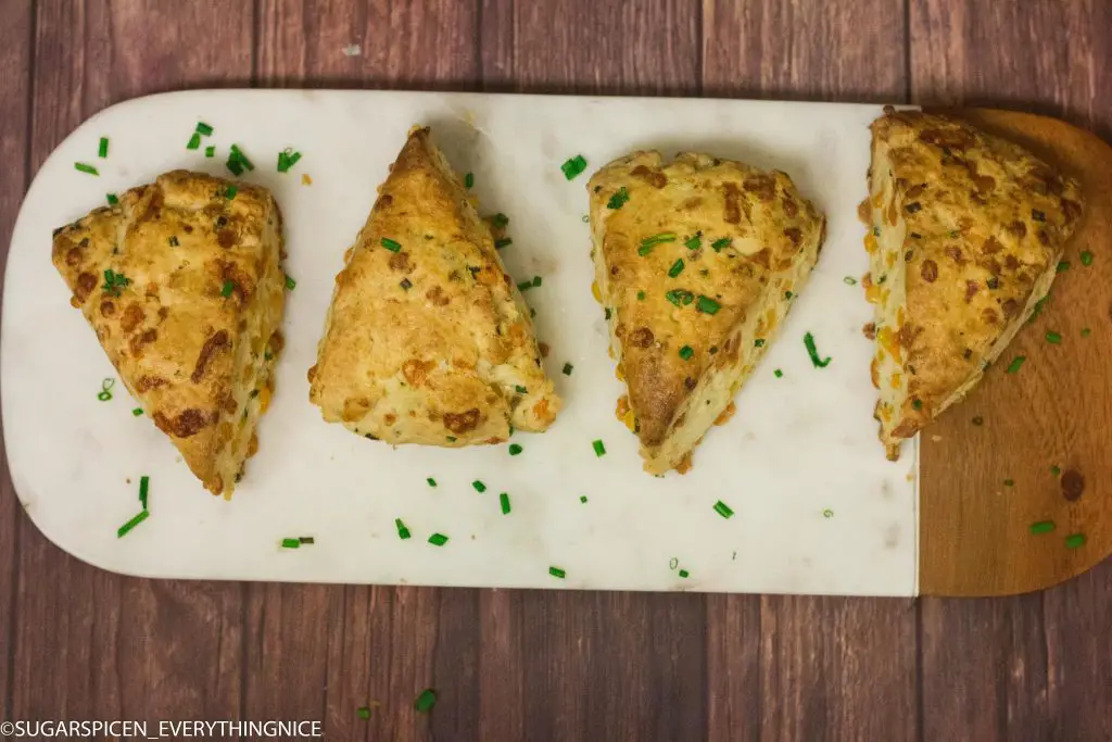 4 cheddar and chives scones kept on a marble board