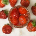 Strawberry Topping Sauce with Strawberries around it