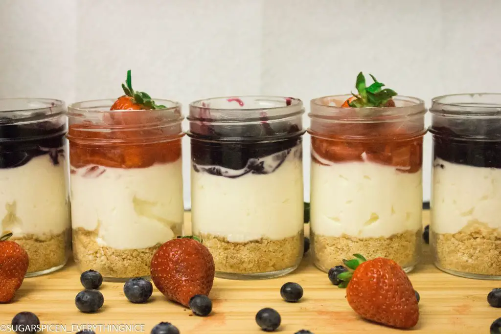 cheesecake in a jar with bluberry and strawberry toppings