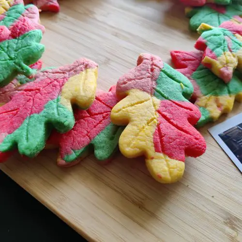 Maple leaf shaped & colored cookies placed laid out as a wreath