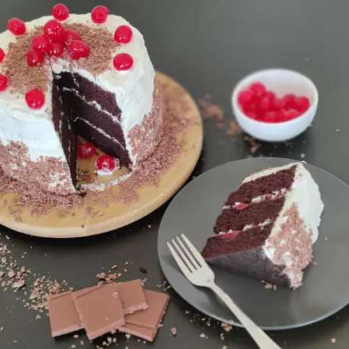 eggless black forest cake with a slice cut out