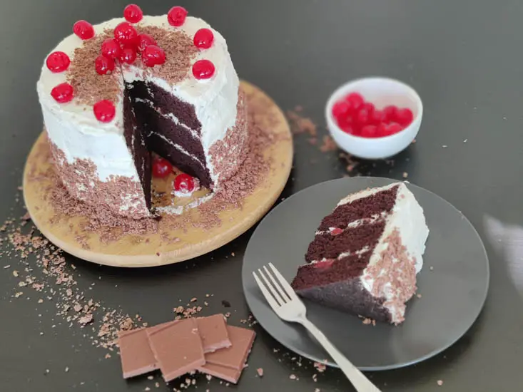 eggless black forest cake with a slice cut out
