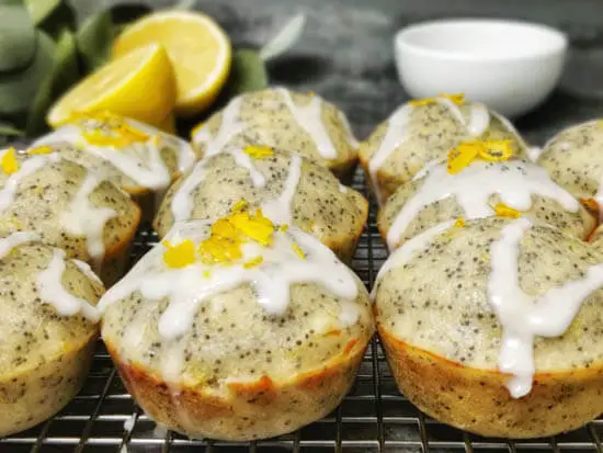 lemon poppy seed muffin with lemon glaze and zest on it