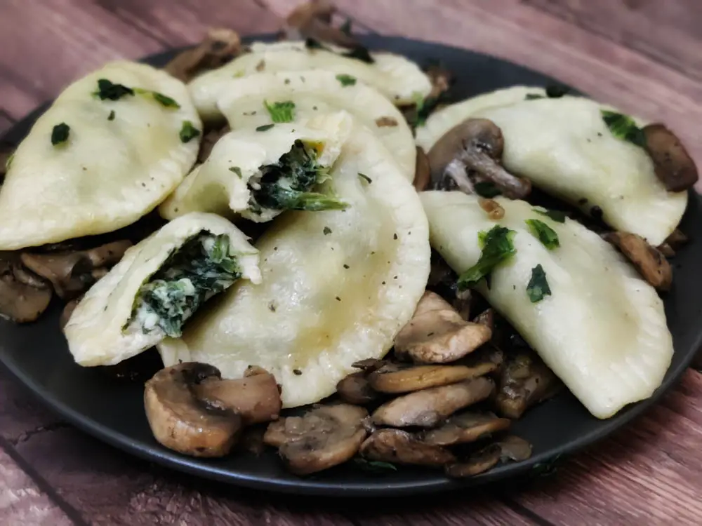 cooked spinach ravioli with served with sauteed mushrooms