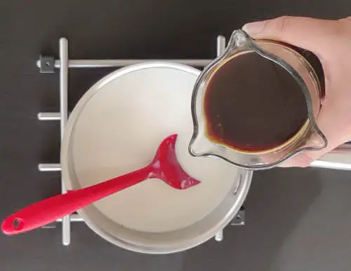 adding cold coffee to pot