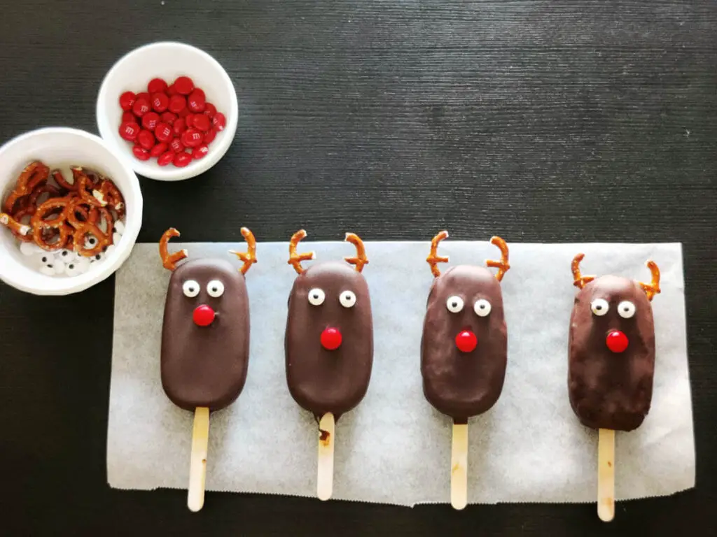 chocolate ice-cream bars kept in a row on top of a parchment paper