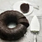 bundt chocolate rum cake cut with one piece placed on a plate