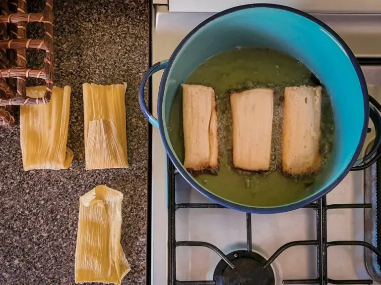 3 tamales frying in a pot
