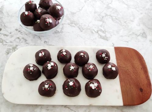 peanut butter bon bons in a bowl and on white tray