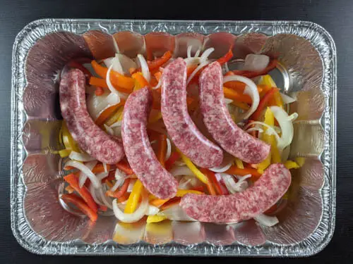 raw brats in a pan