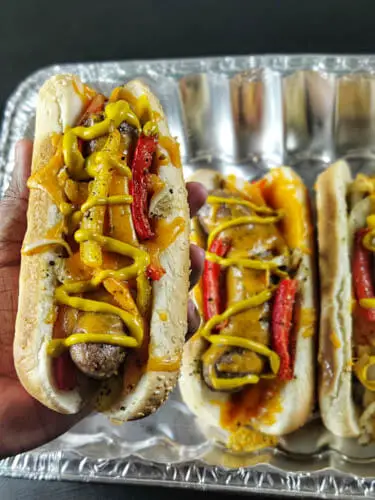 bratwurst hot dogs served with veggies and mustard sauce