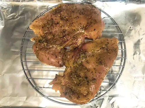 marinated chicken breast with olive oil and italain seasoning, kept over a wire rack,