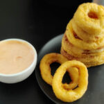 frozen onion rings made in air fryer dipped in chipotle sauce