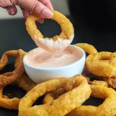 frozen onion rings made in air fryer dipped in chipotle sauce