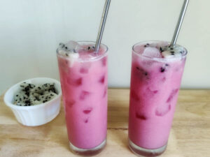 Starbucks Dragon Drink recipe (Copycat) dragon drink served with straw and a ramekin with dice dragonfruit on the side