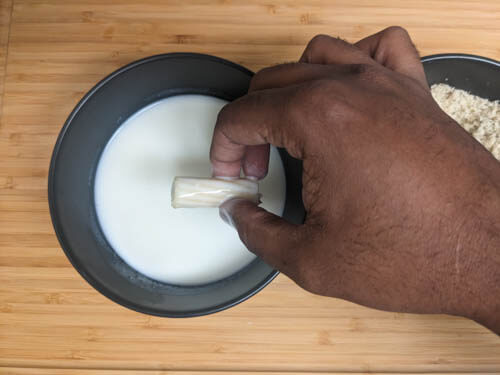 pasta being coated in buttermilk from a bowl