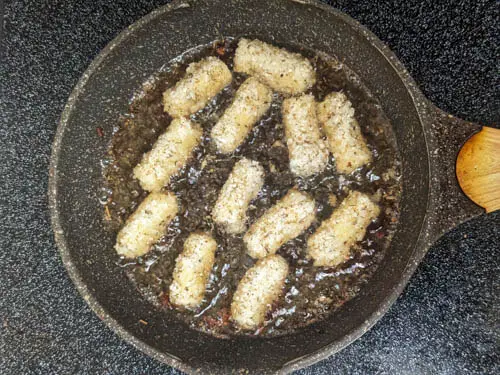 pasta being fried on a medium pan