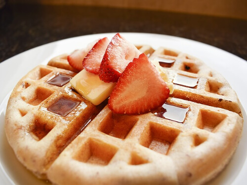 aunt jemima syrup over waffles and strawberry