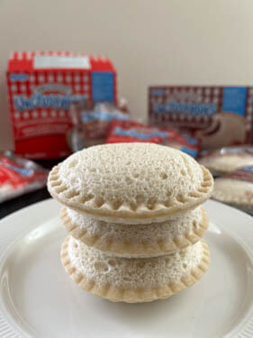 uncrustables stacked up on a white plate