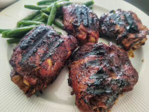 Easy Pulehu Chicken (A Delicious Hawaiian Grilled Delight) pulehu chicken kept on a white plate with a side of peas